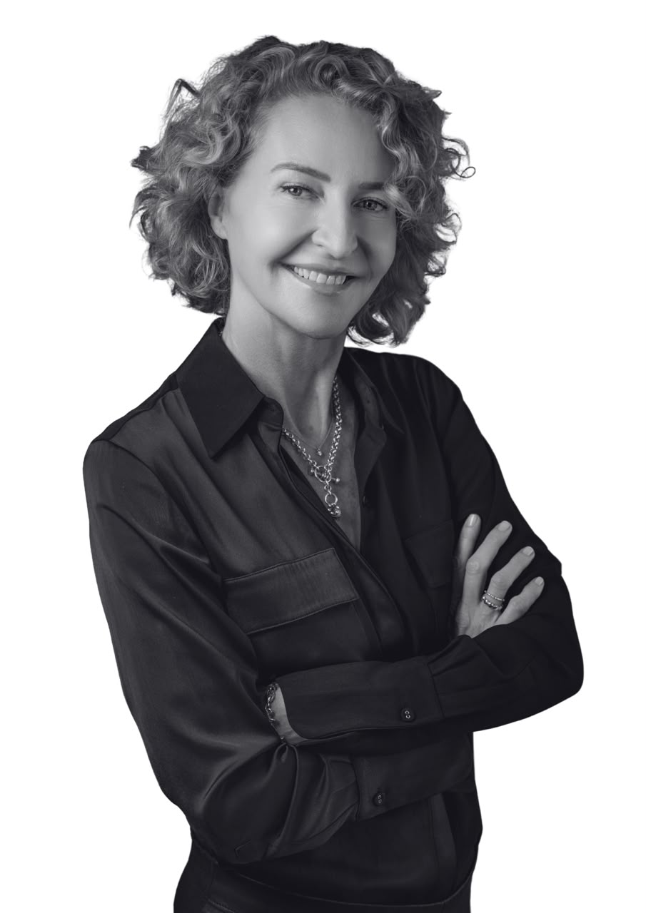 Karen Coetzee, producer at Vertical Cuts, smiling with her arms folded - black-and-white portrait.